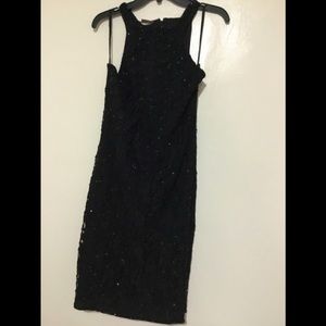 Elegant black shell and rayon sleeveless dress..